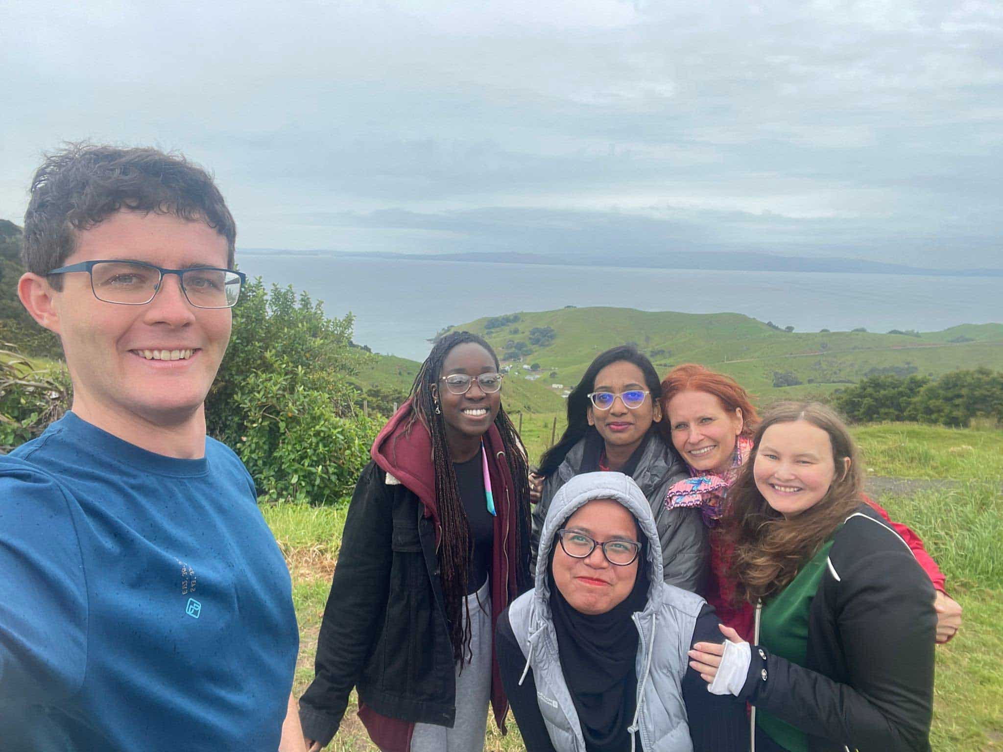 Uche with friends on a mountain